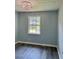 Well-lit bedroom featuring new floors, a modern light fixture, fresh paint, and a bright and airy feel at 6906 Shangrila Way, Riverdale, GA 30296