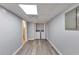 Hallway leading to a laundry area with washer and dryer hookups and modern flooring at 6906 Shangrila Way, Riverdale, GA 30296