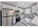 Modern kitchen featuring stainless steel appliances, granite countertops, and white cabinets at 6906 Shangrila Way, Riverdale, GA 30296
