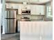 Modern kitchen featuring stainless steel appliances, white cabinets, granite countertops, and stylish backsplash at 6906 Shangrila Way, Riverdale, GA 30296