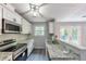 Updated kitchen with stainless steel appliances, granite counters, and an open view to a patio at 6906 Shangrila Way, Riverdale, GA 30296