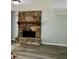 Spacious living room showcasing a striking stone fireplace and plank flooring at 6906 Shangrila Way, Riverdale, GA 30296
