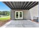 Covered patio featuring a concrete floor, ceiling and backyard with trees at 6906 Shangrila Way, Riverdale, GA 30296