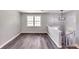Bright room boasts new floors, light gray walls, and modern light fixture at 6906 Shangrila Way, Riverdale, GA 30296