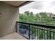 Balcony with black railing overlooking lush greenery and buildings at 3481 Lakeside Ne Dr # 902, Atlanta, GA 30326