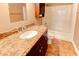 Bathroom featuring granite countertops, dark wood cabinets, and a tub/shower combo at 3481 Lakeside Ne Dr # 902, Atlanta, GA 30326