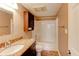 Bathroom featuring granite countertops, dark wood cabinets, and a tub/shower combo at 3481 Lakeside Ne Dr # 902, Atlanta, GA 30326