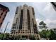 Stunning high-rise condominium building featuring an elegant facade and multiple balconies in a vibrant urban setting at 3481 Lakeside Ne Dr # 902, Atlanta, GA 30326