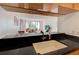 Open kitchen featuring black countertops and open breakfast bar to living room, great for entertaining and everyday living at 3481 Lakeside Ne Dr # 902, Atlanta, GA 30326