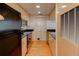 Efficient kitchen with wood cabinets, black appliances, and black countertops, all conveniently designed for easy cooking at 3481 Lakeside Ne Dr # 902, Atlanta, GA 30326