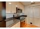 The well-equipped kitchen showcases stainless steel appliances, stylish wood cabinets, and durable black countertops at 3481 Lakeside Ne Dr # 902, Atlanta, GA 30326