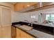 Kitchen featuring black countertops and open breakfast bar to living room, great for entertaining and everyday living at 3481 Lakeside Ne Dr # 902, Atlanta, GA 30326