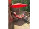 Outdoor deck showcasing a red umbrella, table, and seating amidst a lush green backdrop at 3930 Regal Oaks Dr, Suwanee, GA 30024
