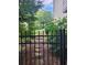 Landscaped backyard featuring a black iron fence and steps leading to upper level at 3930 Regal Oaks Dr, Suwanee, GA 30024