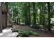 Backyard landscape featuring mature trees and mulched ground cover near the deck at 3930 Regal Oaks Dr, Suwanee, GA 30024