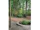 Lush backyard featuring a paver patio and mature trees providing shade at 3930 Regal Oaks Dr, Suwanee, GA 30024