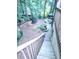 View of the backyard featuring stairs leading to a patio area with lush greenery at 3930 Regal Oaks Dr, Suwanee, GA 30024