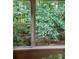 Picture window view of the backyard, showcasing lush green trees and natural scenery at 3930 Regal Oaks Dr, Suwanee, GA 30024