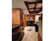 Finished basement wet bar with tile floors, stone accent walls, and a tray ceiling at 3930 Regal Oaks Dr, Suwanee, GA 30024