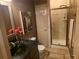 Bathroom featuring tiled shower, stylish vanity, and warm decorative painting at 3930 Regal Oaks Dr, Suwanee, GA 30024