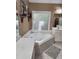 Bathroom featuring a bathtub, a mirror, a vanity, and a patterned window at 3930 Regal Oaks Dr, Suwanee, GA 30024