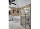 Bathroom featuring a bathtub, shower with gold trim, a vanity, a mirror, and a small window at 3930 Regal Oaks Dr, Suwanee, GA 30024