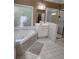 A well-lit bathroom with a jacuzzi tub and a separate shower stall at 3930 Regal Oaks Dr, Suwanee, GA 30024
