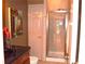 This bathroom features a glass enclosed shower, dark countertop vanity, and neutral wall paint at 3930 Regal Oaks Dr, Suwanee, GA 30024