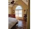 Bedroom filled with natural light from arched window, hardwood floors, and classic furnishings at 3930 Regal Oaks Dr, Suwanee, GA 30024