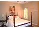 Cozy bedroom featuring a four-poster bed with bright natural light and decorative wall art at 3930 Regal Oaks Dr, Suwanee, GA 30024