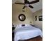 Bedroom with a ceiling fan, a large bed with white linens, and a round mirror at 3930 Regal Oaks Dr, Suwanee, GA 30024