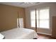 Bedroom with hardwood floors, two windows with white blinds, and neutral paint at 3930 Regal Oaks Dr, Suwanee, GA 30024