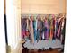 Walk-in closet fully stocked with clothing and shoes at 3930 Regal Oaks Dr, Suwanee, GA 30024
