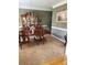 Traditional dining room with wood table, chairs, carpet and elegant lighting fixture at 3930 Regal Oaks Dr, Suwanee, GA 30024