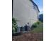 Exterior of the home featuring siding, a window, and air conditioning units on a well-maintained lot at 3930 Regal Oaks Dr, Suwanee, GA 30024