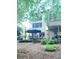 Exterior backyard featuring a patio area with seating, mature landscaping, and an umbrella at 3930 Regal Oaks Dr, Suwanee, GA 30024