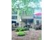 Back exterior view of the house with a patio, deck, and lush landscaping at 3930 Regal Oaks Dr, Suwanee, GA 30024