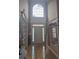 Grand foyer with hardwood floors, high ceilings, and a large window above the front door at 3930 Regal Oaks Dr, Suwanee, GA 30024