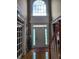 Elegant entryway featuring a high ceiling, transom window, hardwood floors, and decorative door at 3930 Regal Oaks Dr, Suwanee, GA 30024