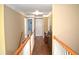 Upstairs hallway featuring hardwood floors, white door, and stair railings at 3930 Regal Oaks Dr, Suwanee, GA 30024