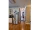 Hallway view of stainless steel refrigerator and eat-in kitchen at 3930 Regal Oaks Dr, Suwanee, GA 30024