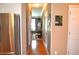 Hallway view showing access to rooms and a kitchen with stainless steel appliances at 3930 Regal Oaks Dr, Suwanee, GA 30024