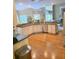Bright, open kitchen with white cabinets, stainless appliances, granite countertops, and hardwood floors at 3930 Regal Oaks Dr, Suwanee, GA 30024