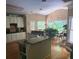 Spacious kitchen with granite countertops, white cabinets, hardwood floors, and a view of the backyard at 3930 Regal Oaks Dr, Suwanee, GA 30024
