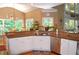 Well lit kitchen featuring light cabinets, a granite counter top, a stainless steel dishwasher and a view of the backyard at 3930 Regal Oaks Dr, Suwanee, GA 30024