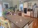 Kitchen featuring granite counters, stainless appliances, white cabinets, hardwood floors and bar stool seating at 3930 Regal Oaks Dr, Suwanee, GA 30024