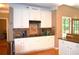 Well-appointed kitchen featuring white cabinets, granite countertops, and modern appliances at 3930 Regal Oaks Dr, Suwanee, GA 30024