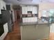 Kitchen with white cabinets, stainless refrigerator, granite counters, and island at 3930 Regal Oaks Dr, Suwanee, GA 30024
