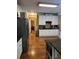 Well-lit kitchen featuring white cabinets, granite countertops, and hardwood flooring at 3930 Regal Oaks Dr, Suwanee, GA 30024