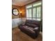 Cozy living room features a comfortable leather loveseat and large windows at 3930 Regal Oaks Dr, Suwanee, GA 30024